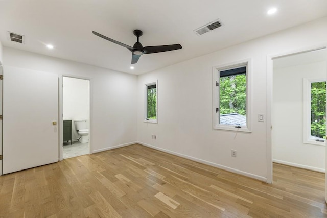 unfurnished bedroom featuring baseboards, visible vents, and light wood finished floors