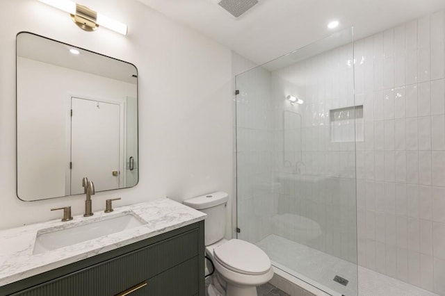 full bath with a walk in shower, vanity, toilet, and visible vents