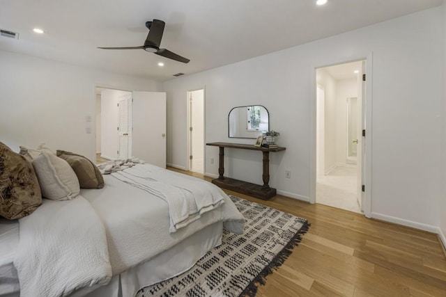 bedroom with visible vents, recessed lighting, wood finished floors, and connected bathroom