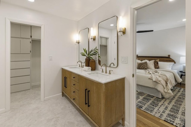 full bathroom with double vanity, recessed lighting, a sink, and ensuite bath
