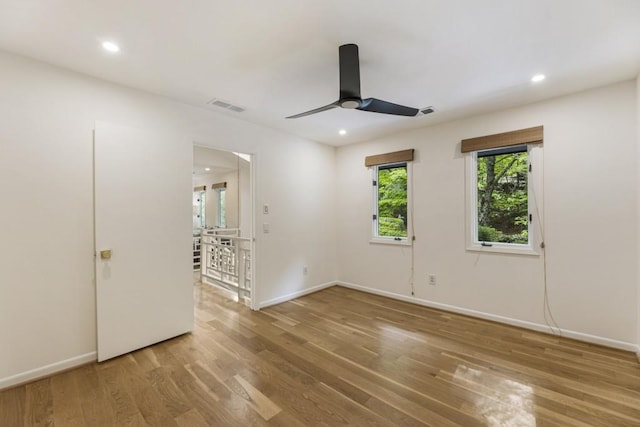 unfurnished room featuring visible vents, baseboards, ceiling fan, and wood finished floors