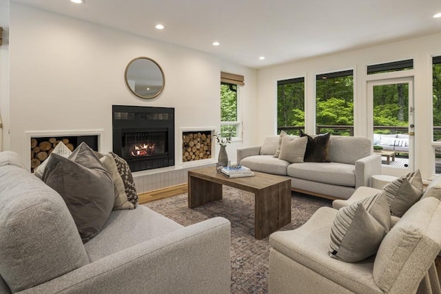 living area with recessed lighting, wood finished floors, and a fireplace