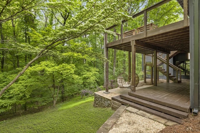 view of yard featuring a deck and stairs