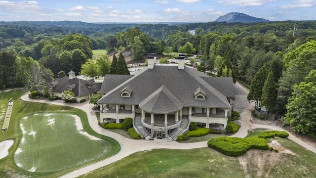 birds eye view of property with a wooded view