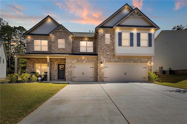 craftsman house featuring a garage, a lawn, and central AC unit