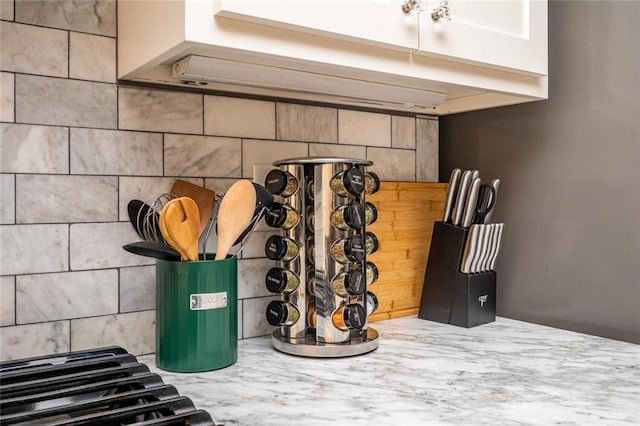 details with decorative backsplash and light countertops