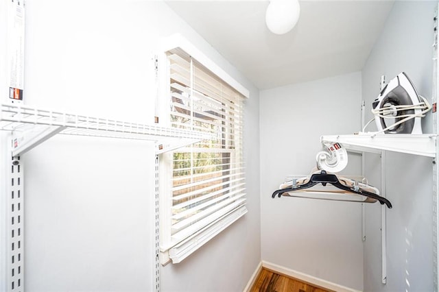 walk in closet featuring wood finished floors