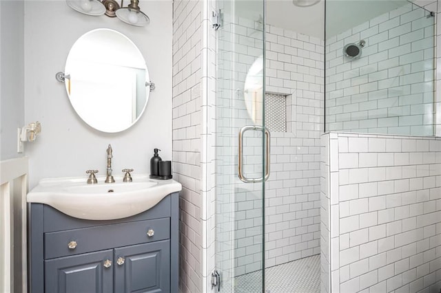 bathroom with a shower stall and vanity