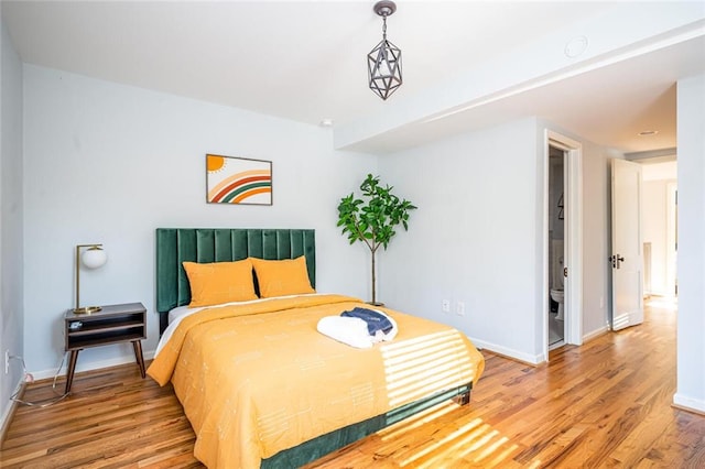 bedroom with baseboards and light wood finished floors