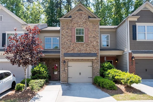 multi unit property featuring brick siding, concrete driveway, and an attached garage