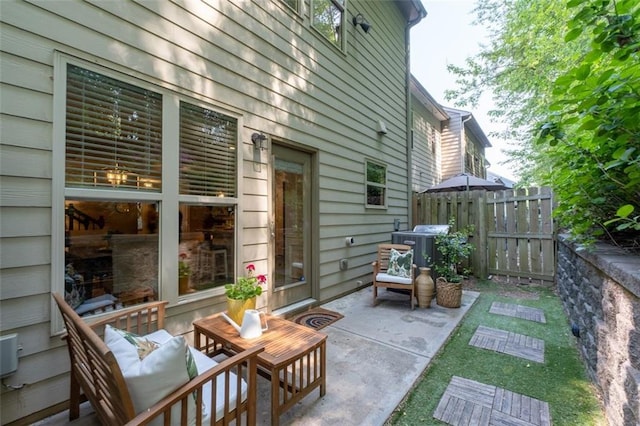 view of patio / terrace featuring fence and central AC unit