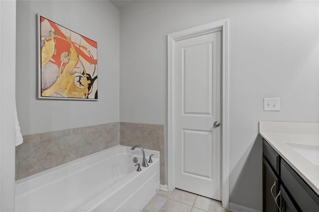 full bath with a garden tub, vanity, and tile patterned floors
