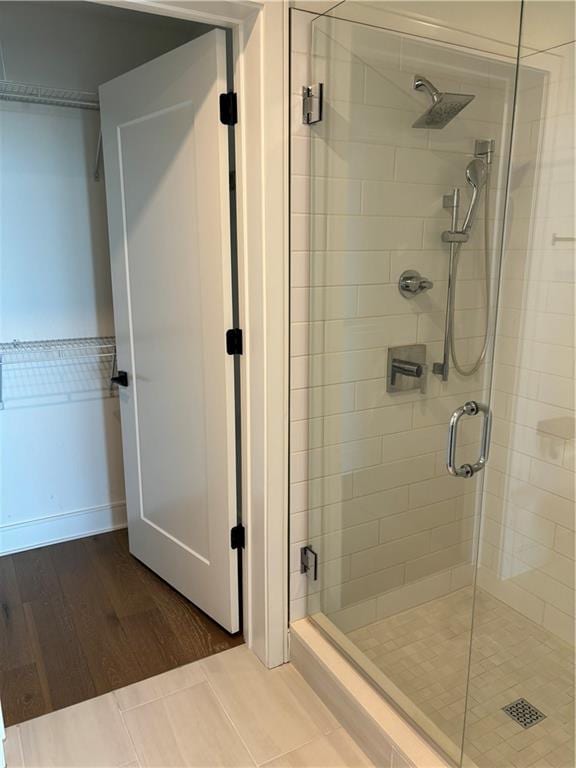 bathroom featuring an enclosed shower and hardwood / wood-style floors