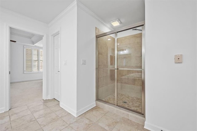 bathroom featuring crown molding, baseboards, a shower stall, and tile patterned floors