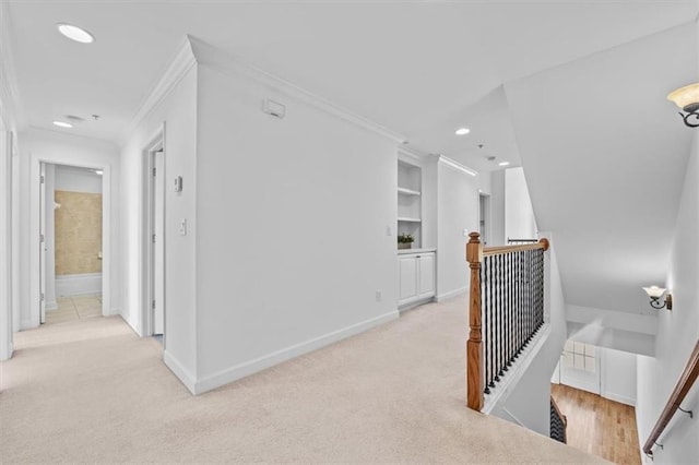 hallway featuring light colored carpet, an upstairs landing, ornamental molding, and recessed lighting