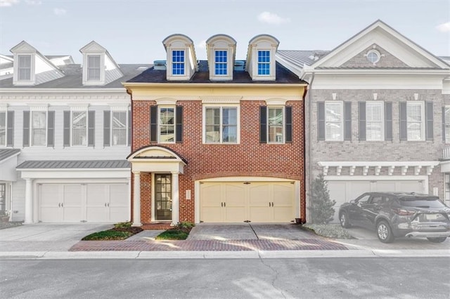 view of front of home with an attached garage, driveway, and brick siding