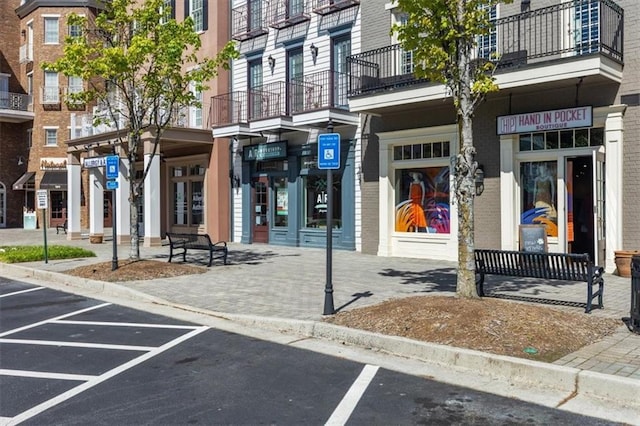 property entrance with brick siding and uncovered parking