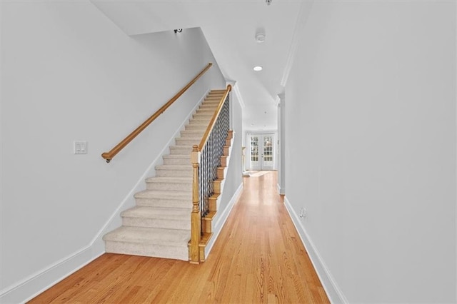 stairway featuring baseboards and wood finished floors