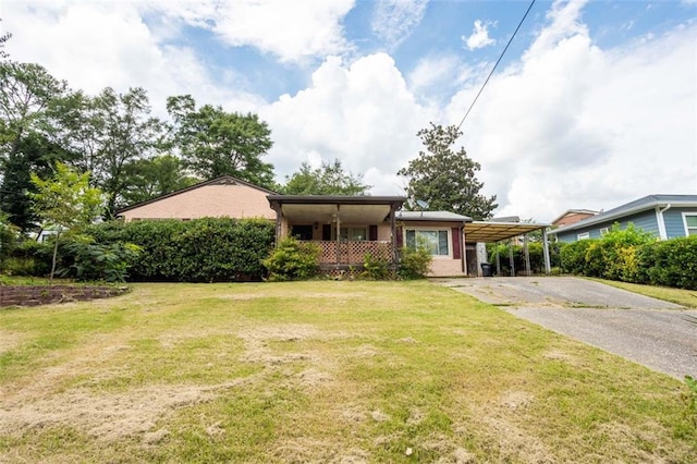 ranch-style home with driveway, a front lawn, and a carport