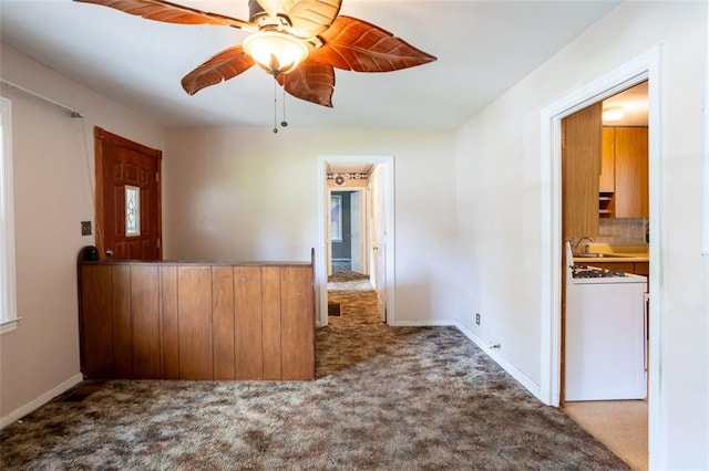 interior space with light colored carpet, sink, and ceiling fan