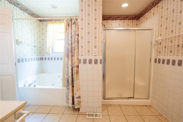 bathroom with tile patterned floors and separate shower and tub