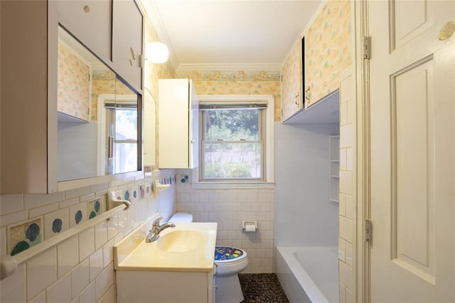 full bathroom featuring backsplash, toilet, vanity, tile walls, and bathing tub / shower combination