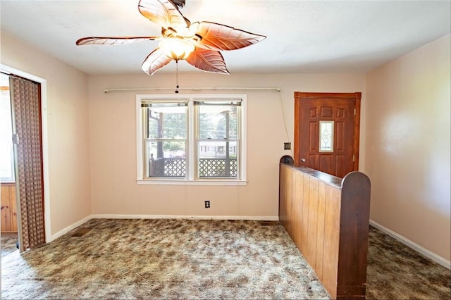 carpeted foyer entrance featuring ceiling fan