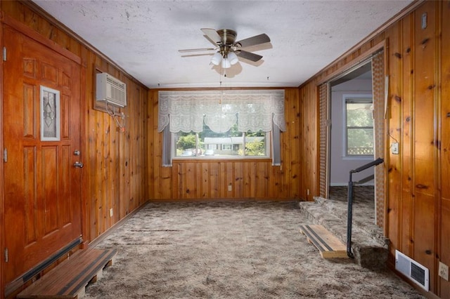 empty room featuring crown molding, carpet, a wealth of natural light, and ceiling fan