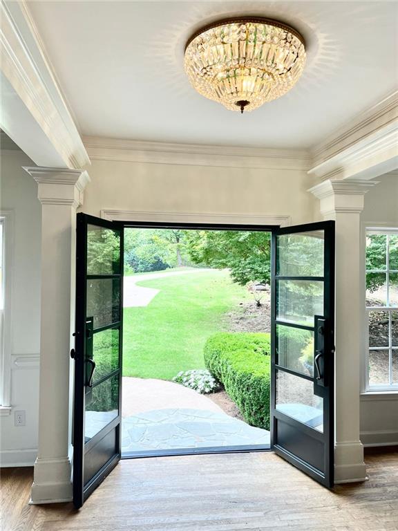 8525 Anchor On Lanier Ct, Gainesville, GA 30506 - entryway with ornate columns, wood finished floors, baseboards, and crown molding