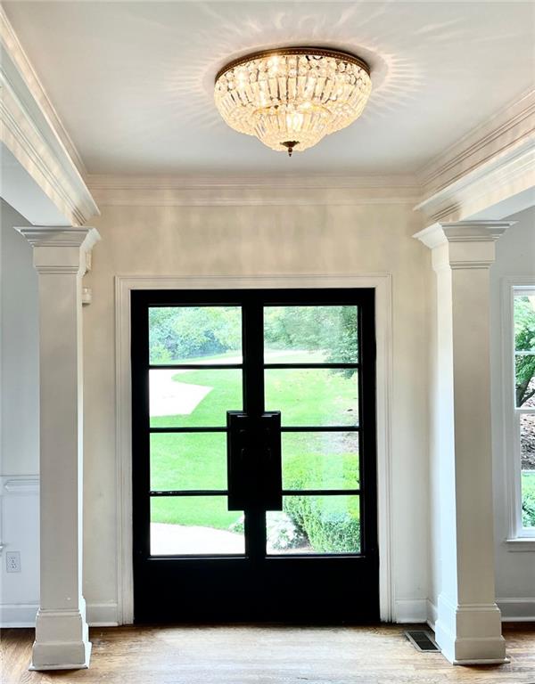8525 Anchor On Lanier Ct, Gainesville, GA 30506 - doorway with ornate columns, wood finished floors, ornamental molding, and baseboards