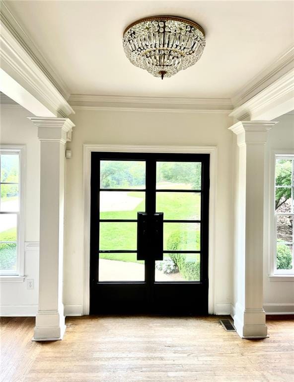 8525 Anchor On Lanier Ct, Gainesville, GA 30506 - entryway with ornate columns, ornamental molding, light wood finished floors, and baseboards