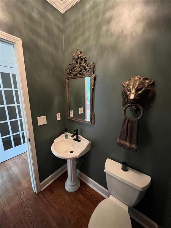 8525 Anchor On Lanier Ct, Gainesville, GA 30506 - half bath with wood finished floors, crown molding, baseboards, and toilet