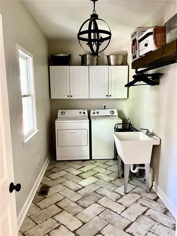 8525 Anchor On Lanier Ct, Gainesville, GA 30506 - laundry area featuring cabinet space, separate washer and dryer, baseboards, and a chandelier
