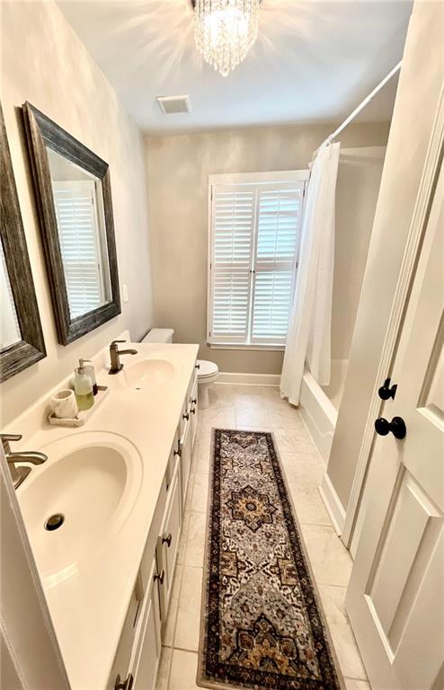 8525 Anchor On Lanier Ct, Gainesville, GA 30506 - full bath featuring toilet, double vanity, tile patterned floors, and shower / tub combo