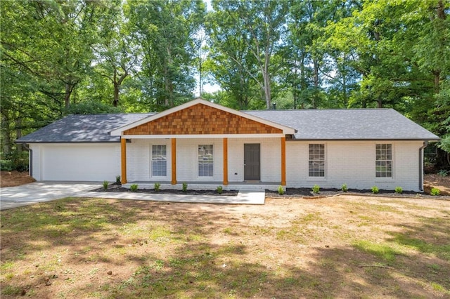 single story home featuring a garage, a front lawn, and covered porch