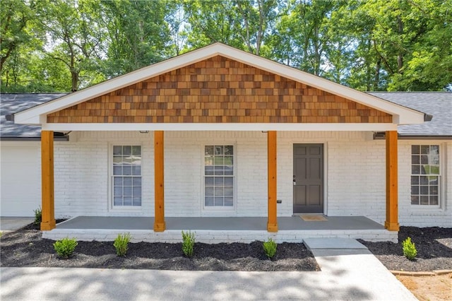 single story home with a garage and a porch