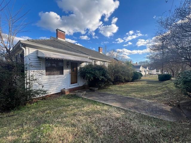 view of side of home featuring a yard