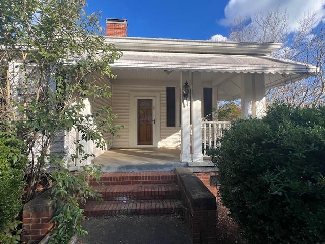 doorway to property with a porch