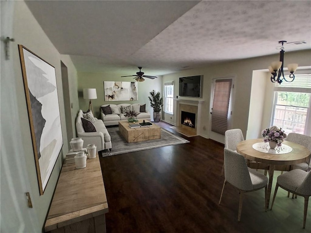 5320 Taylor Rd, Alpharetta, GA 30022 - living room featuring a fireplace with flush hearth, healthy amount of natural light, wood finished floors, a ceiling fan, and a textured ceiling