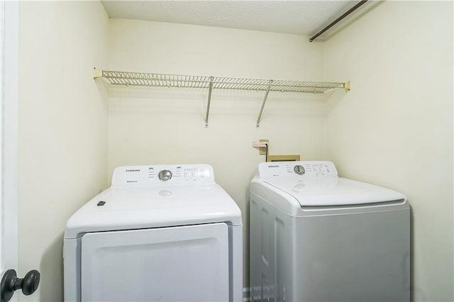 washroom with washing machine and clothes dryer