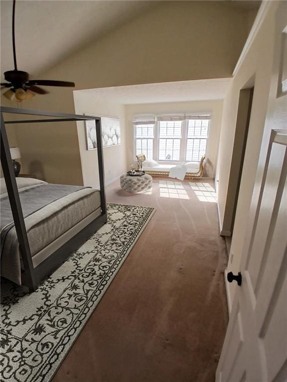 carpeted bedroom with high vaulted ceiling