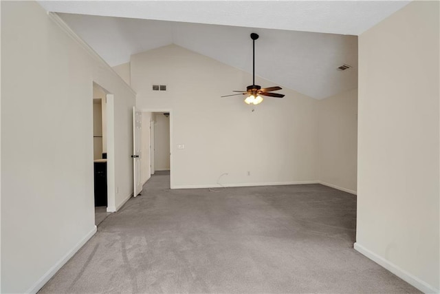 empty room featuring ceiling fan, light colored carpet, baseboards, and high vaulted ceiling