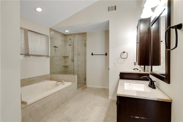 full bath featuring a garden tub, a shower stall, vaulted ceiling, double vanity, and baseboards