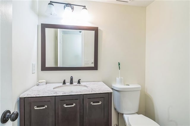 half bath with vanity and toilet
