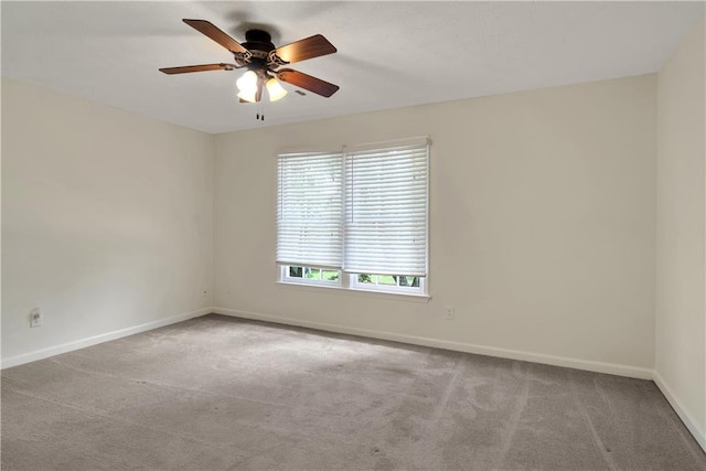 empty room featuring carpet flooring and baseboards