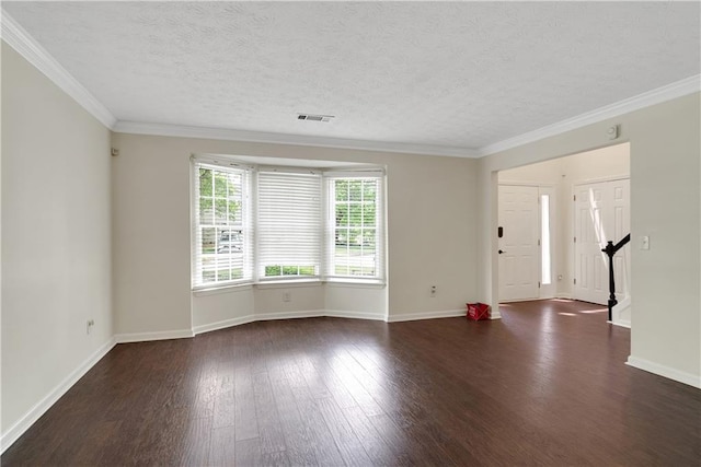 unfurnished living room with dark wood finished floors, baseboards, a textured ceiling, and crown molding