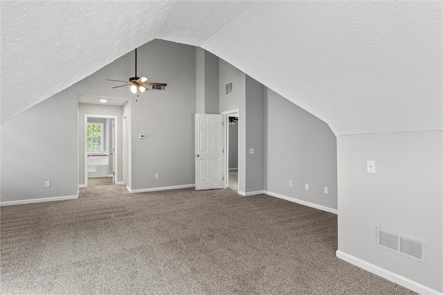 bonus room with carpet, vaulted ceiling, a textured ceiling, and ceiling fan