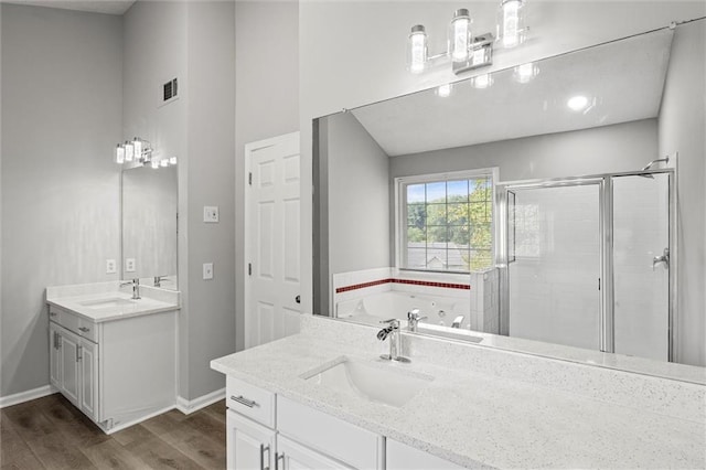 bathroom with vanity, wood-type flooring, and separate shower and tub