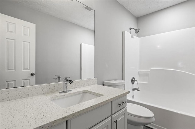 full bathroom with vanity, toilet, shower / bath combination, and a textured ceiling