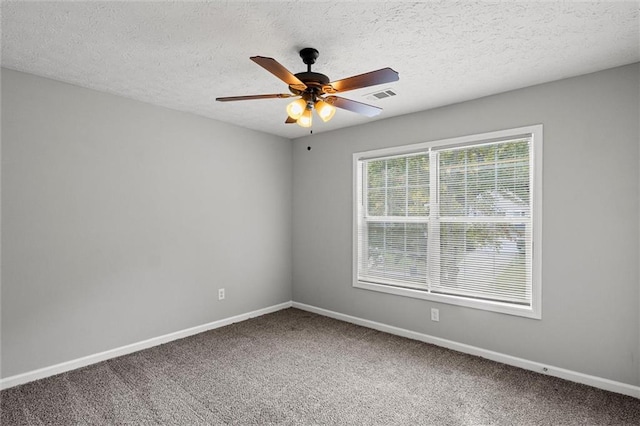 spare room featuring a textured ceiling, carpet floors, and ceiling fan